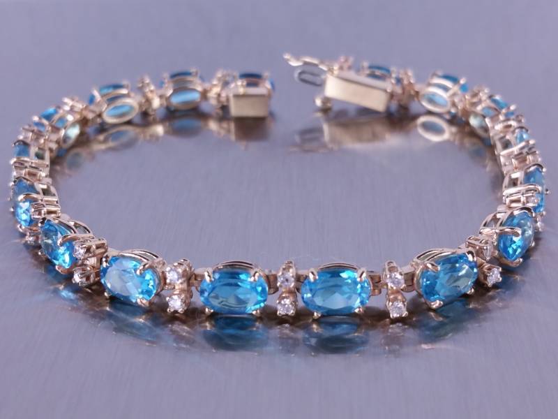lot 6 image: Natural Blue Topaz & Diamond Tennis Bracelet in 14k Gold