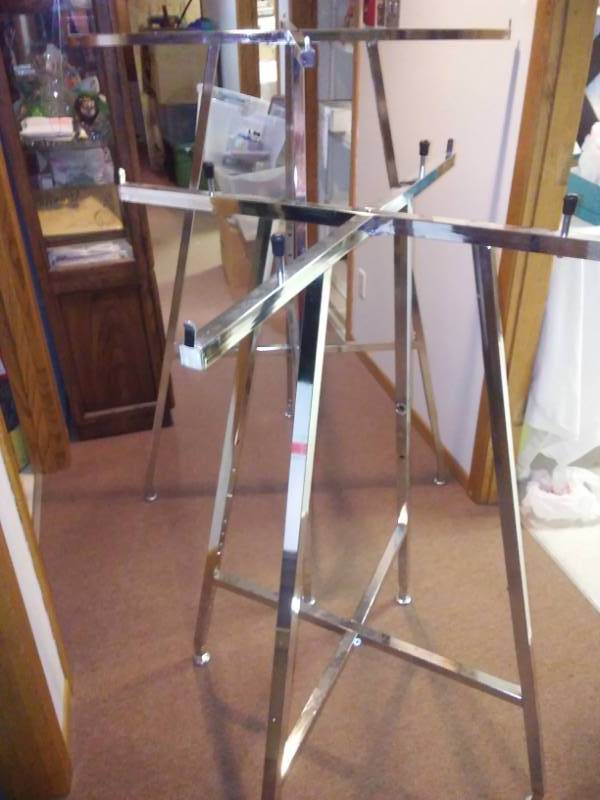 lot 32 image: 2 collapsible commercial clothing racks.
