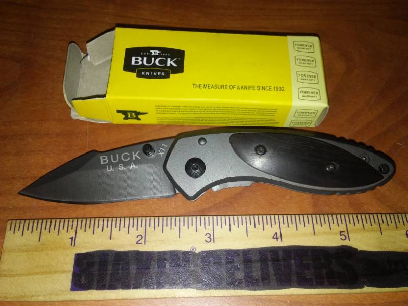 lot 145 image: Buck knife foldable pocket knife at 11. Wood handled accents, 5.75 in.