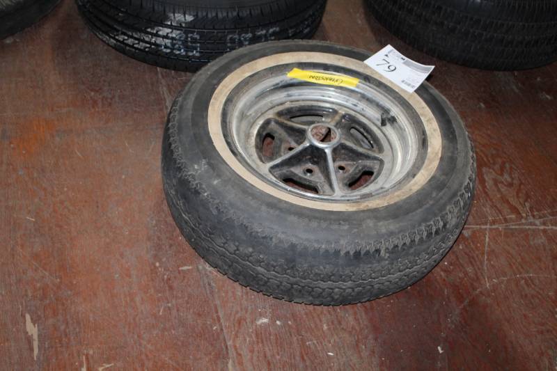 lot 79 image: P21575R14 Whitewall Tire w 14in. 5-Lug Pontiac Wheel