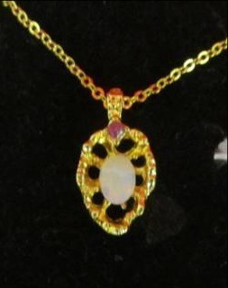 lot 84 image: Opal & Ruby with gold plated chain (jeweler appraised value $59.95