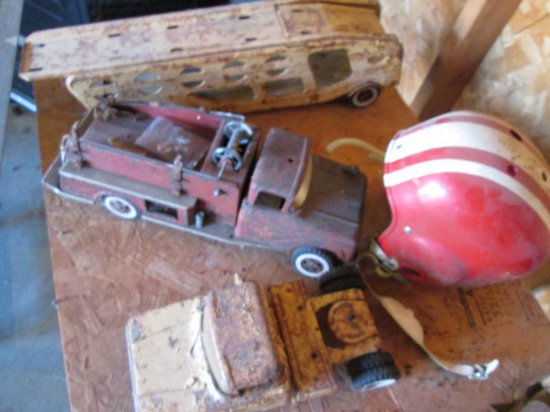 lot 71 image: Vintage metal toys and helmet...