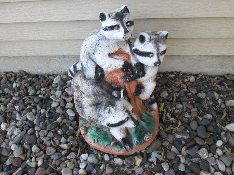 lot 102 image: Cement racoon ornament...