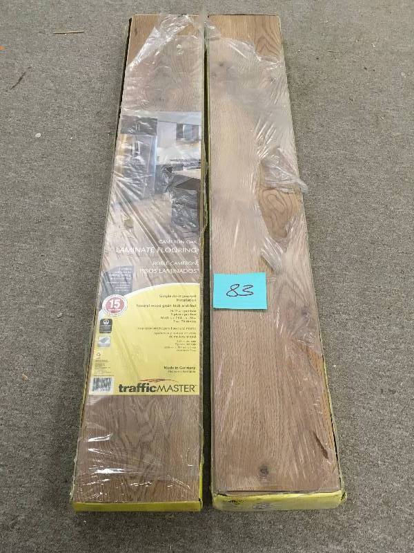 lot 83 image: TrafficMASTER Cameron Oak 7 mm Thick x 7-23 in. Wide x 50-58 in. Length Laminate Flooring (24.17 sq. ft.  case)  LOT OF 2 CASES