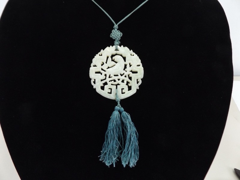 lot 61 image: Authentic Carved White Jade 2.125 Medallion Silk Necklace