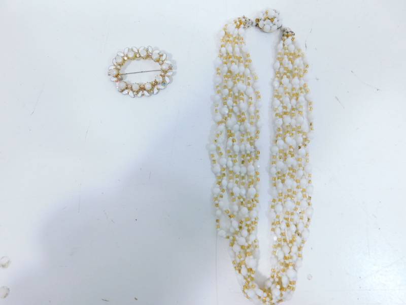 lot 70 image: Seven Strand White Beaded Necklace & A White Beaded Broach