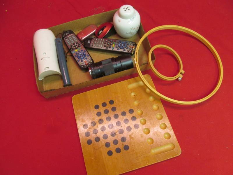 lot 198 image: camera lens, TV remotes, game board