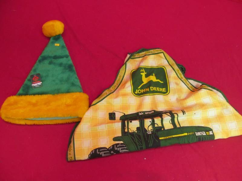 lot 102 image: new Santa hat, John Deere apron
