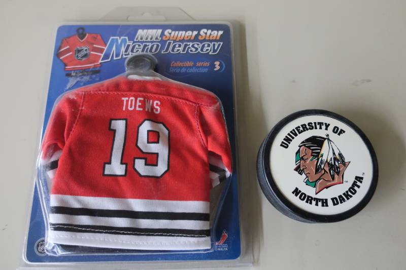 lot 516 image: UND Sioux Puck & Toews Blackhawks Micro Jersey
