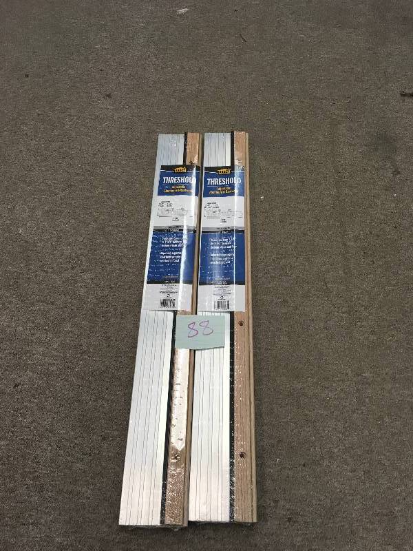 lot 88 image: LOT OF 2 M-D Building Products 4-916 in. x 36 in. Satin Aluminum and Oak Adjustable Threshold not used