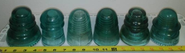 lot 9 image: 6 green glass insulators - variety.