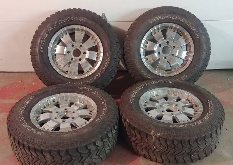 lot 100 image: Set of 4 Chevy Truck Rims w salvage tires