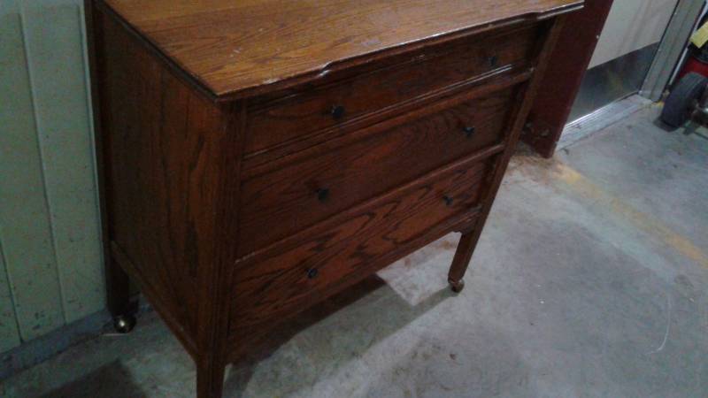 lot 7 image: Wood Bedroom Dresser On Wheels, Used, Shows Wear, One Legs Looks Like It Has Been Repaired