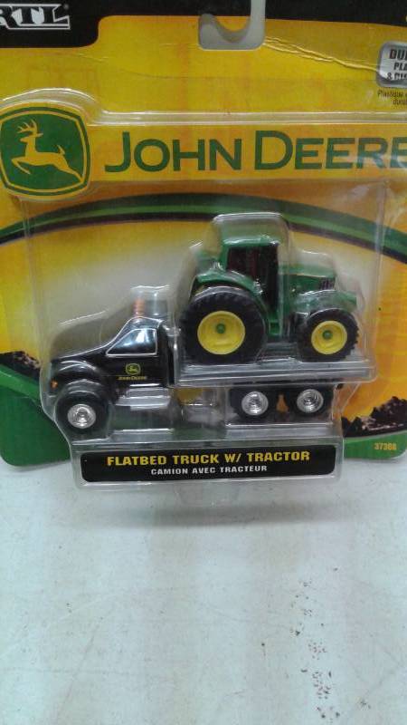 lot 73 image: New Ertl John Deere Tractor On Trailer, Some Wear To Package, Around 4 Long