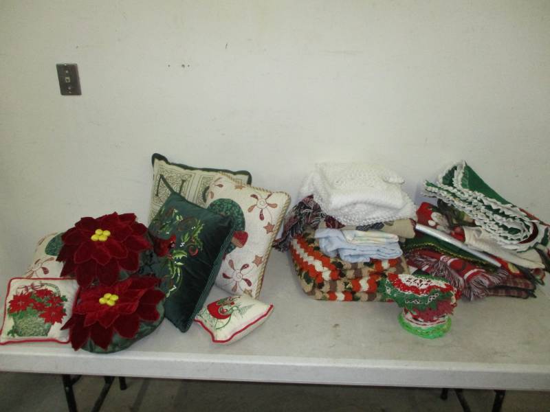 lot 70 image: Various Christmas Pillows and linens, blankets, table clothes.
