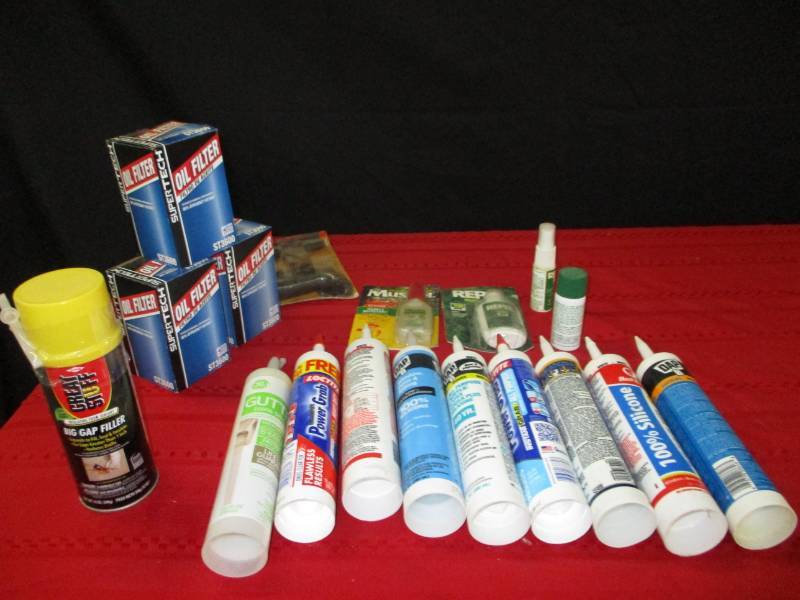 lot 116 image: Tire repair kid,oil filters, various silicone glues, insect repellant and gap filler