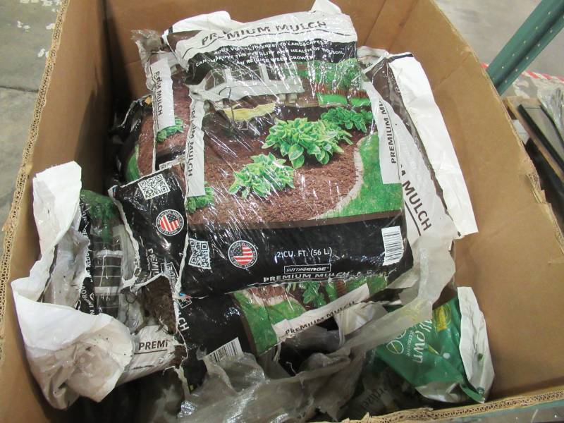 lot 66 image: Pallet of Approximately 10 bags 2 cu. ft. Premium Quality Brown mulch and a few bags of fertilizer.