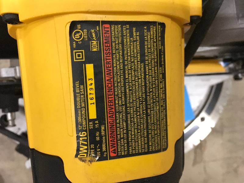 lot 26 image: DEWALT DW716 12 in. Double-Bevel Compound Miter Saw Used works missing Dust bag