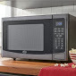 lot 8 image: 1.2 Cubic Foot Microwave by Ginnys...