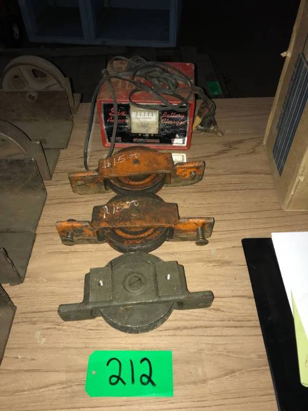 lot 212 image: Three individual metal pulley, 1 wbrass wheel (vintage) 6 amp battery charger Schumacker 612 volts made in US