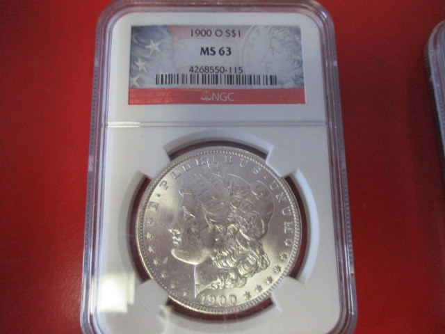 lot 11 image: NGC Certified (Stars and Stripes Limited Edition Logo) 1900-O (New Orleans Mint) Morgan Silver Dollar  4268550-115 certification number.