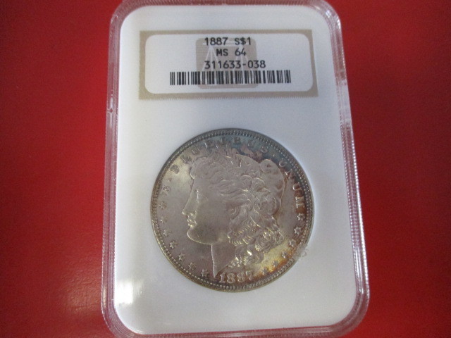 lot 14 image: NGC Certified (Old Logo) 1887-P (Philadelphia Mint) Morgan Silver Dollar  311633-038 certification number. Has light Rainbow Toning on Top ObverseBottom Reverse  Beautiful Coin.