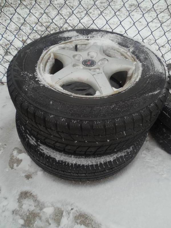 (2) PONTIAC RIMS WITH 2157015 TIRES