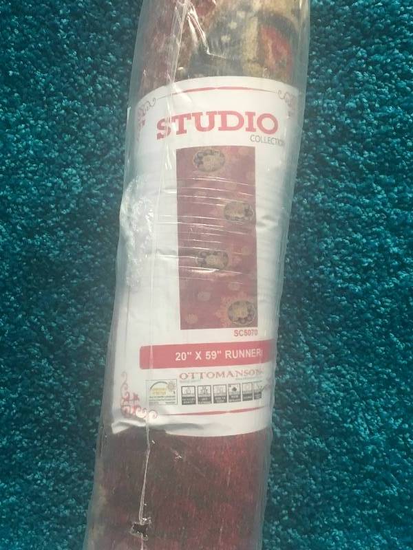lot 16 image: Ottomanson Studio Collection Red Medallion Design 20X59 Area Rug not used
