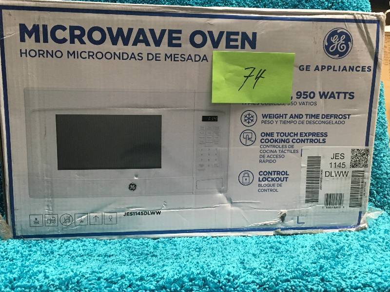 lot 74 image: GE 1.1 cu. ft. Countertop Microwave in White in good working condition