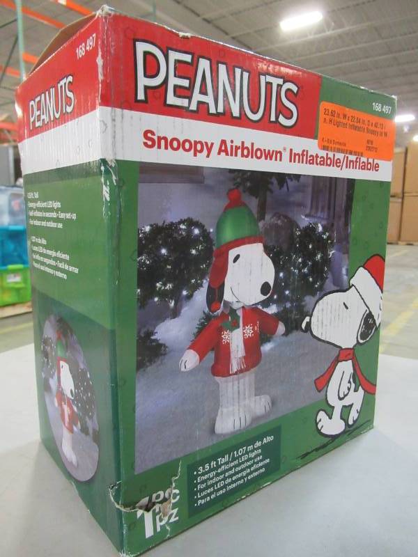 lot 43 image: Home Accents Holiday 23.62 in. W x 22.84 in. D x 42.13 in. H Lighted Inflatable Snoopy in Winter Wear, Model 39910