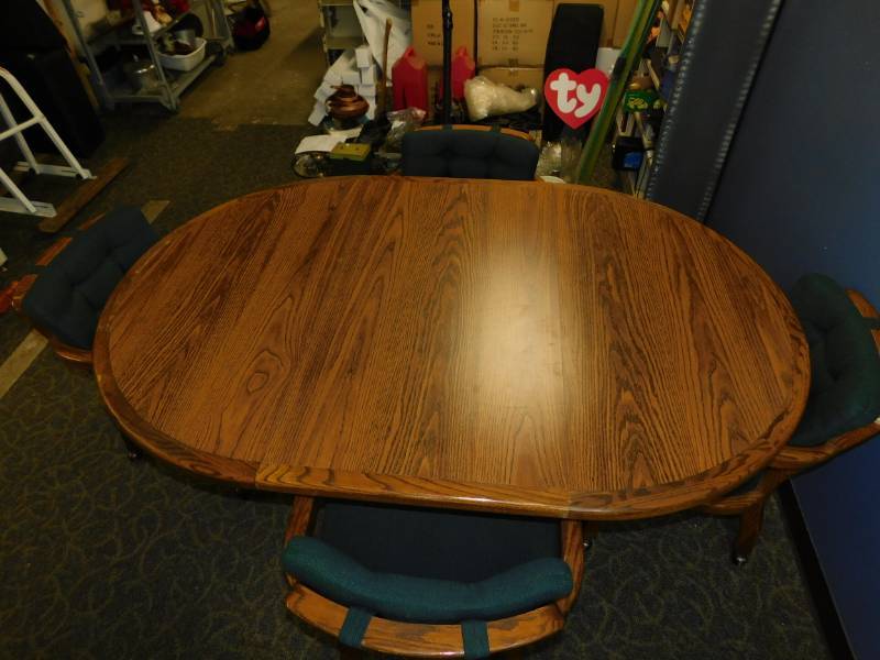 lot 51 image: Dining Room Table With One Leaf And Four Chairs On Casters