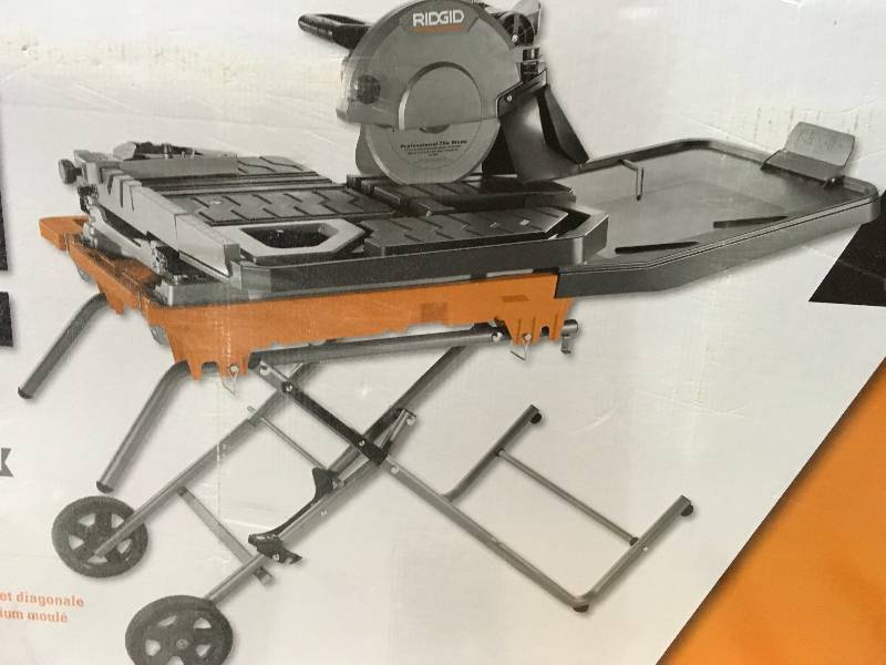 lot 18 image: Ridgid 10 in. Wet Tile Saw with Stand  in like new condition