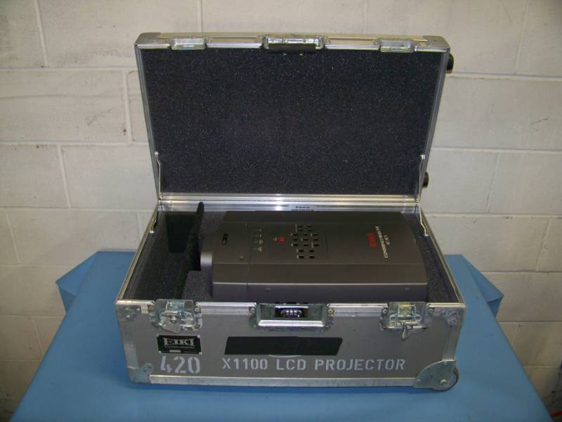 lot 70 image: EIKI, LC-XC1, LCD Projector in Hard Sided, Padded Inside Travel  Shipping Case with Telescoping Handle on Wheels
