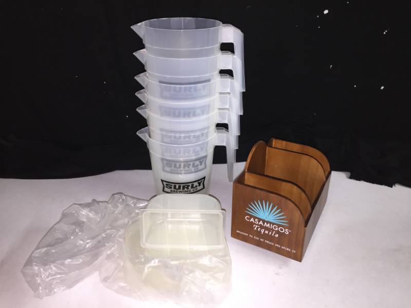 lot 244 image: Casamigos Tequila napkin holder and Surly Beer pitchers