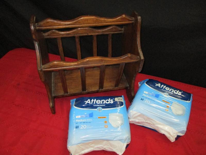 2 Packs of unopened Depends and Magazine Rack