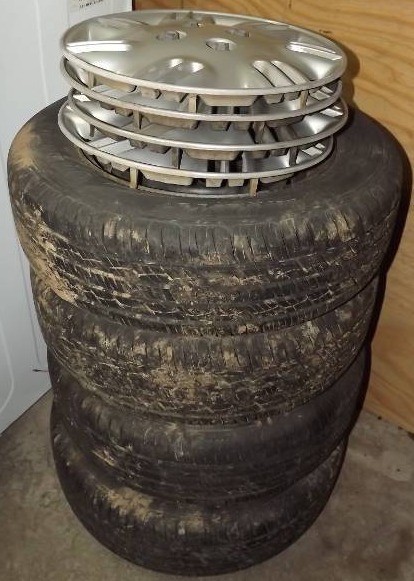 lot 15 image: Four Tires with Rims and Hubcaps