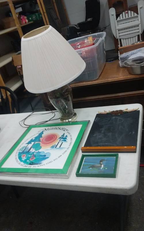 lot 24 image: Pine Cone Filled Glass Lamp With Shade, 3-Wall Art Pieces-Cabin Theme.