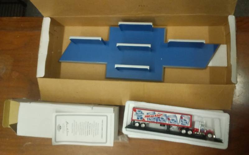 lot 54 image: Match Box Collectible Pabst Blue Ribbon Peter Built Truck & Trailer With COA & Chevy Bow Tie Display Shelf
