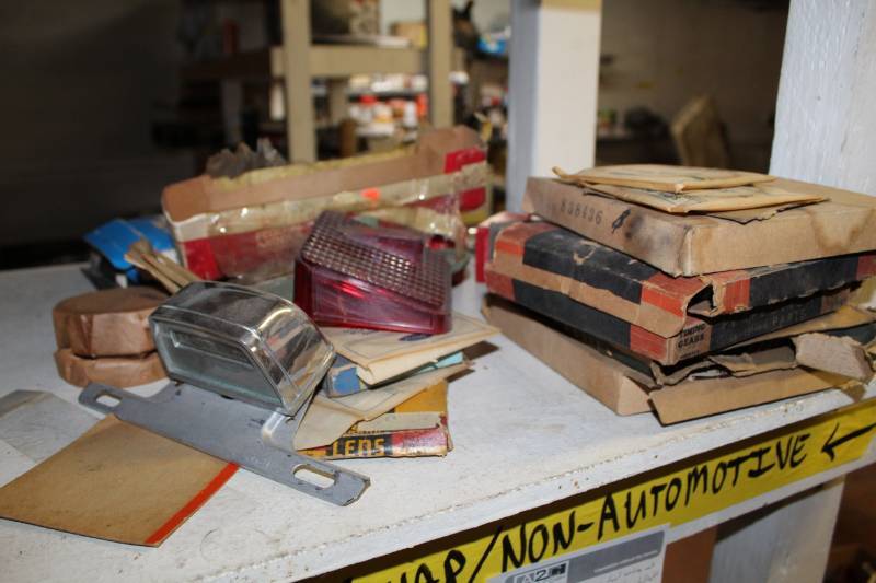 lot 113 image: NOS, Timing Gears, Piston Rings, Clock, Taillight Cover, Engine Bearings, Chrome Fins