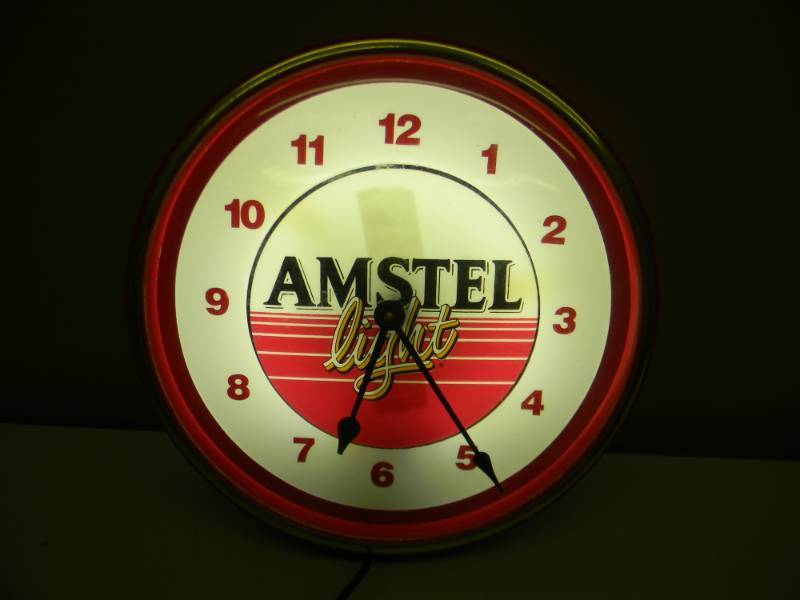 lot 26 image: AMSTEL LIGHT BEER LIGHTED CLOCK - LIGHT WORKS - CLOCK NEEDS A BATTERY, DID NOT TEST - APPROX 14 - SEE PICTURES