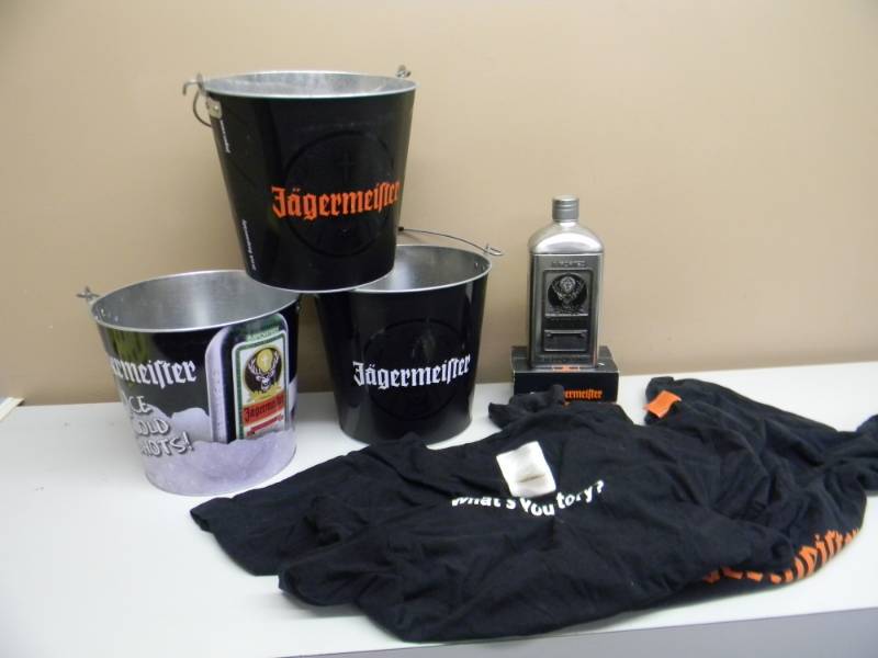 lot 40 image: JAGERMEISTER COLLECTION - 6 NEW IN BOX SHOT GLASSES, STASH TIN, 3 BUCKETS & 4 PROMOTIONAL T SHIRTS - SEE PICTURES