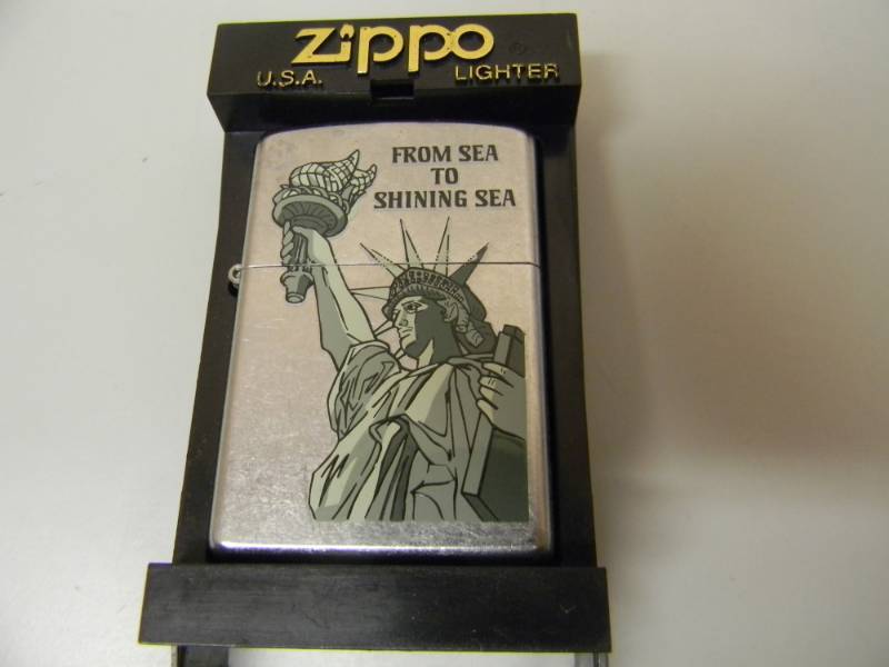 lot 52 image: NOS STILL IN THE BOX FROM SEA TO SHINNING SEA ZIPPO LIGHTER - SEE PICTURES