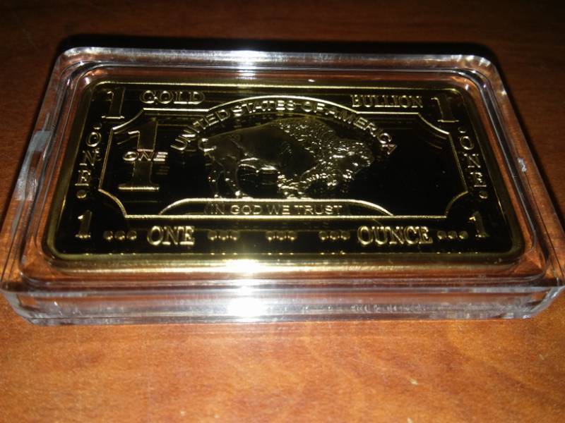lot 53 image: NDSU Bison gold plated one troy ounce 100 Mills .999 fine gold.