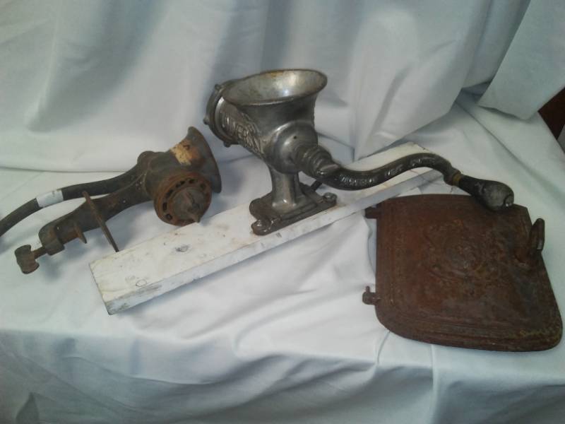 lot 164 image: 2 antique Grinders and cast stove door.
