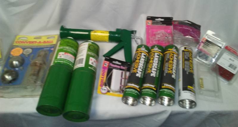 lot 203 image: Miscellaneous convert a ball trailer set, hardware, caulk and more in a tote.