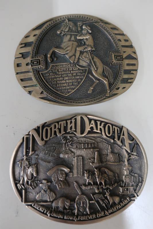 lot 391 image: Two Solid Brass North Dakota Belt Buckles