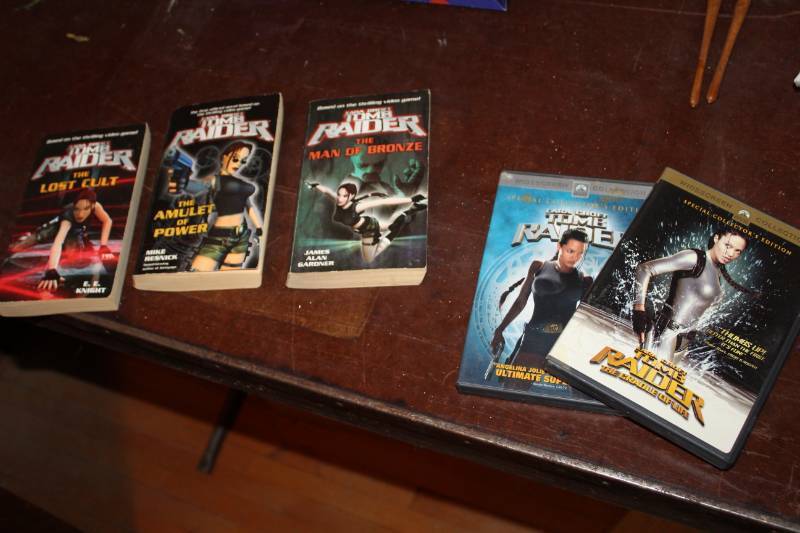 lot 247 image: Tomb Raider DVD, Tomb Raider The Cradle of Life DVD, Tomb Raider The Man of BronzeThe Amulet of PowerThe Lost Cult Paperback Books