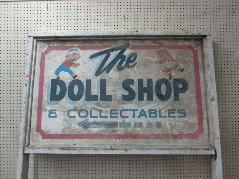 lot 2 image: The Doll Shop Sign