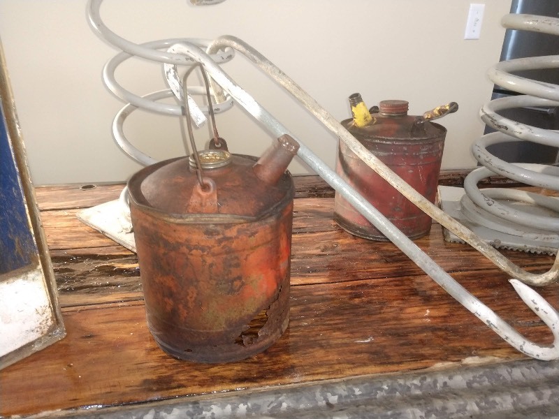 lot 12 image: Industrial Steampunk Springs, Meat Hooks, Cast Iron Cobbler Shoe Form, Vintage Gas Station Galvanized Metal Oil Can and Vintage Metal Oil Cans w Spout