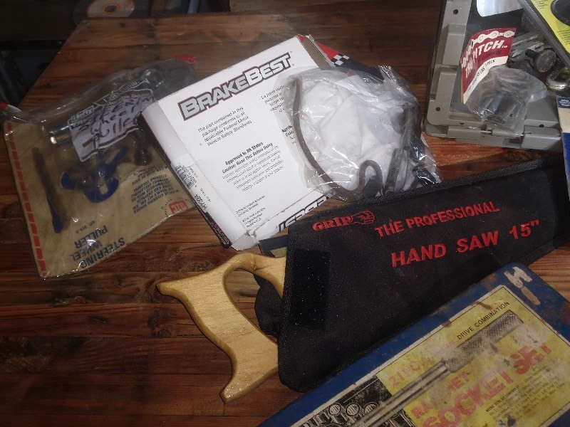 lot 29 image: Cutting Wheel w Wooden Case, 21 Piece Ratchet Socket Set, GRIP The Professional Handsaw 15, Steering Wheel Puller and Other Steering Wheel Parts